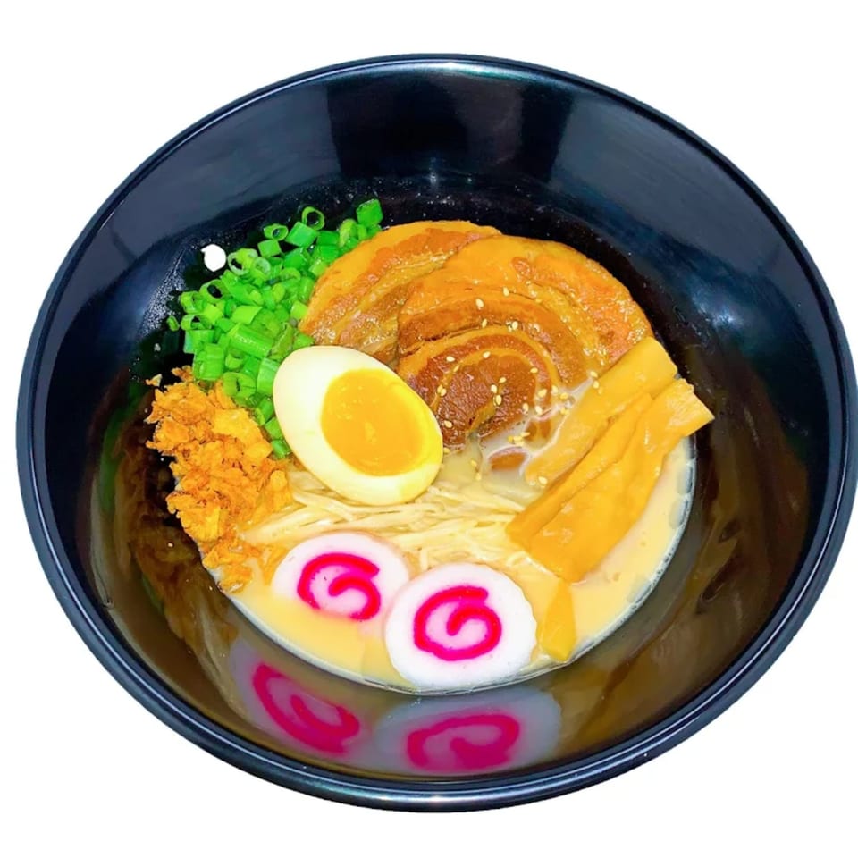 Aroma Ramen's tonkotsu ramen with pork belly, egg, narutomaki, scallions, and bamboo shoots.